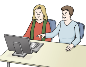 Zwei Personen an einem Computer. Die eine Person erklärt der anderen etwas am Bildschirm.